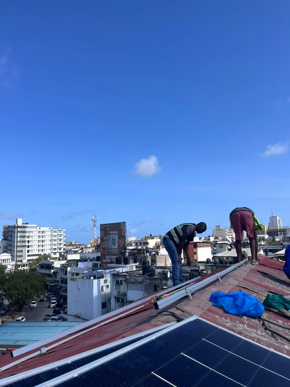 PCLEINE technicians mounting solar panel rails on pitched rooftop in Bondeni Mombasa