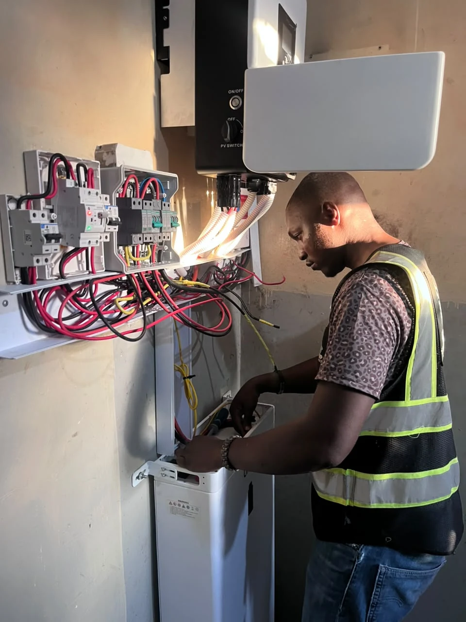 Certified technician wiring automatic transfer switch and battery cabling