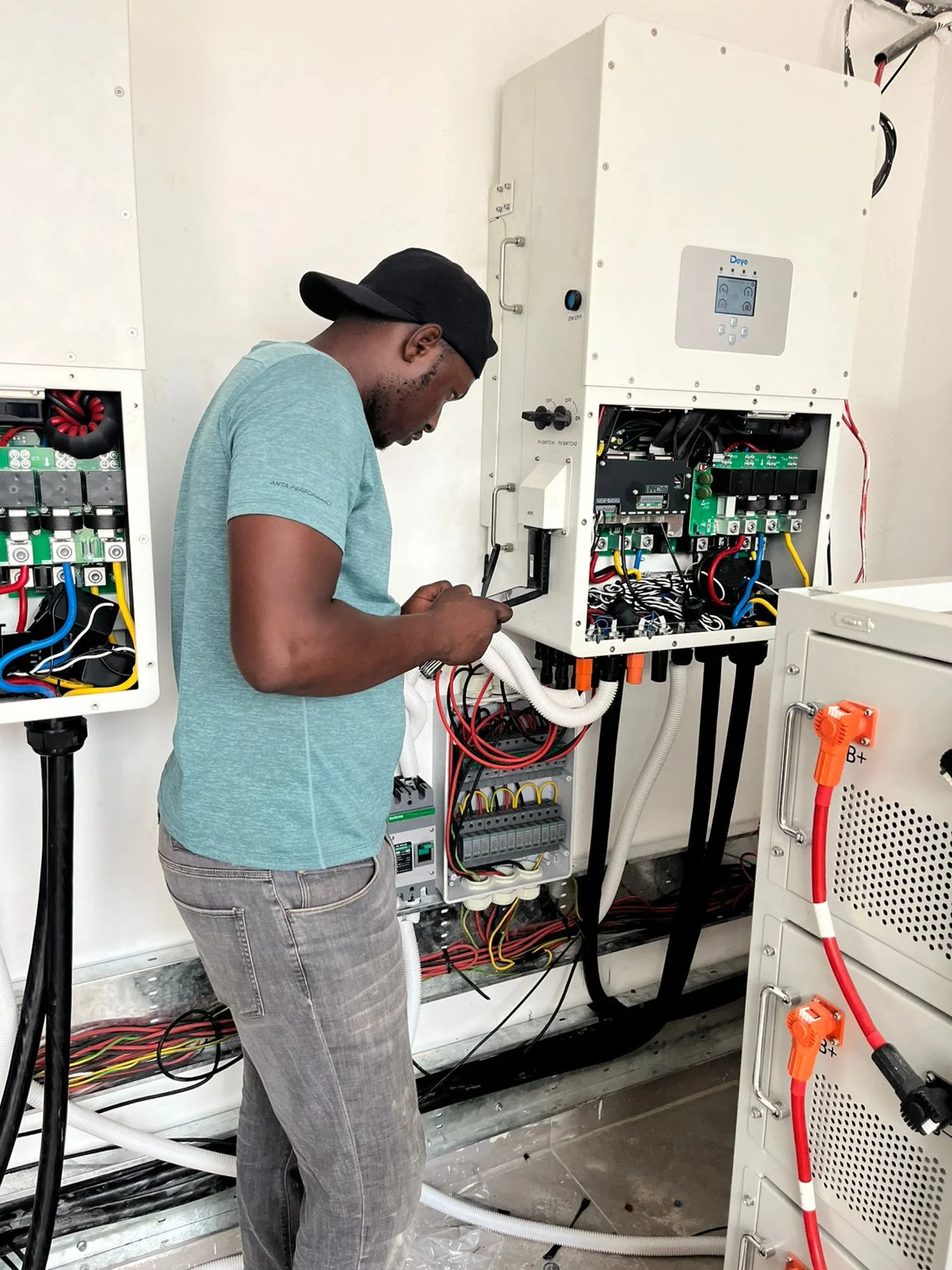 PCLEINE technician wiring a Deye commercial inverter