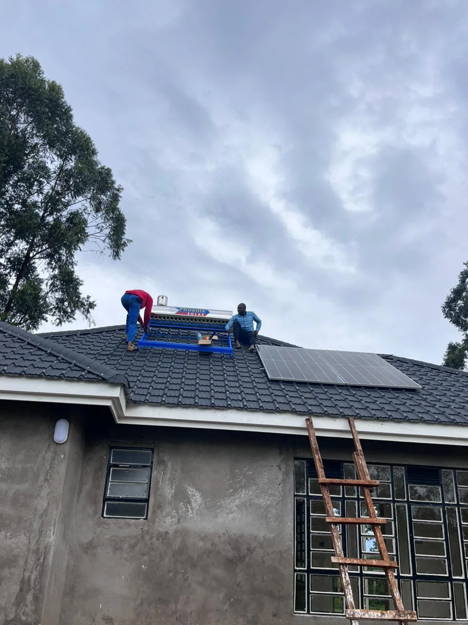 PCLEINE team installing a Phoenix Solar water heater on rooftop